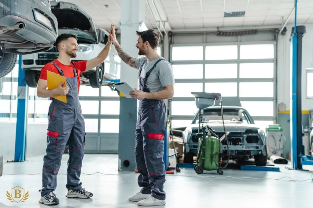 A clean, well-organized garage with technicians working on cars.